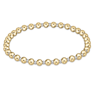 Gold and silver beaded bracelet on a white background by e newton