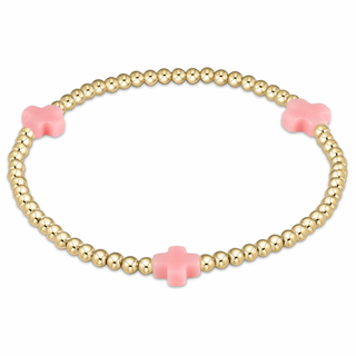 Gold beaded bracelet with pink flower-shaped beads by enewton on a white background