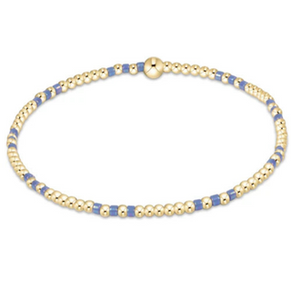 Gold and blue beaded bracelet on a white background
