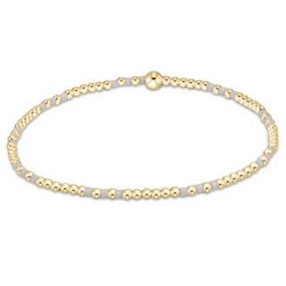 Gold beaded bracelet on a white background