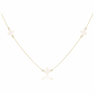 Gold necklace with white stones on a white background enewton