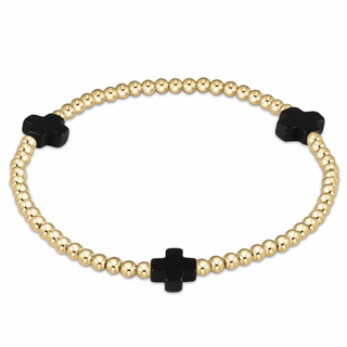 Gold beaded bracelet with black clover-shaped beads by enewton on a white background