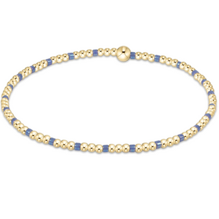 Gold and blue beaded bracelet on a white background