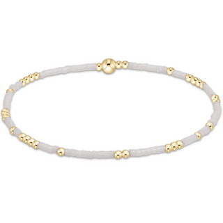 Necklace with white beads and gold accents on a white background