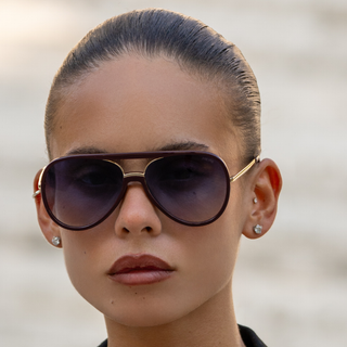 Close-up of a person wearing sunglasses with a blurred background