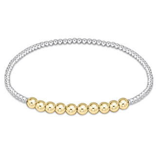 Beaded bracelet with alternating gold and silver beads on a white background by e newton