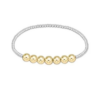 Gold beaded bracelet on a white background by e newton