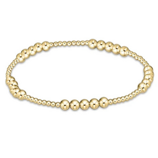 Gold beaded bracelet on a white background by enewton