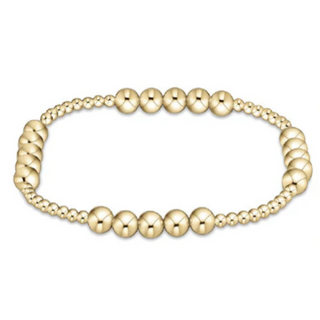 Gold beaded bracelet on a white background by e newton