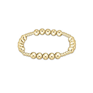Gold beaded bracelet on a white background by enewton
