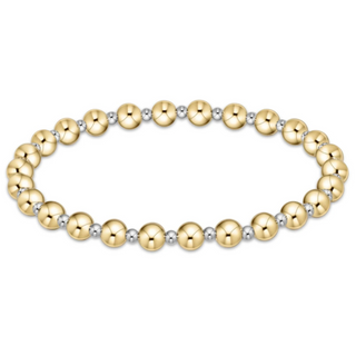 Gold and silver beaded bracelet on a white background by enewton