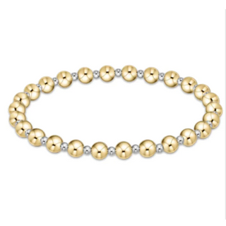 Gold and silver beaded bracelet on a white background by enewton
