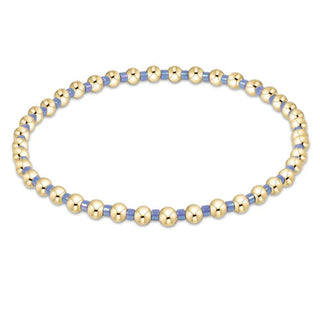 Bracelet with gold and blue beads on a white background by enewton
