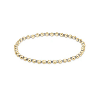 Beaded bracelet with gold and silver beads on a white background by e newton