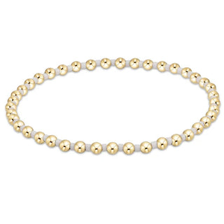 Bracelet with gold and white beads on a white background by e newton