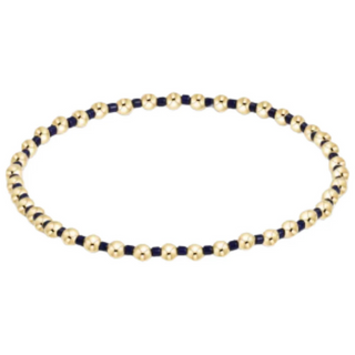 Bracelet with gold and navy beads on a white background by e newton