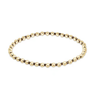 Gold beaded bracelet on a white background by enewton