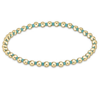 Bracelet with gold and turquoise beads on a white background by e newton