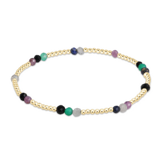 Necklace with gold beads and multicolored stones on a white background by e newton