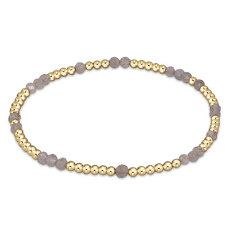 Bracelet with gold and gray beads on a white background by enewton