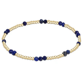 Bracelet with gold and blue beads on a white background by enewton