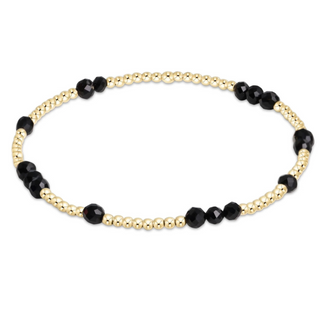 Beaded necklace with gold and black beads on a white background by enewton