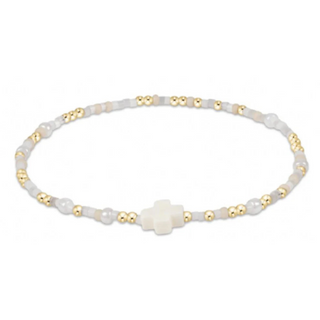 Bracelet with white beads and gold accents on a white background