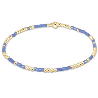 Bracelet with blue and gold beads on a white background