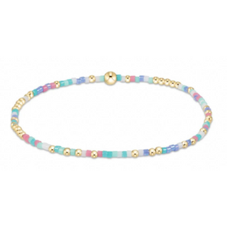 Beaded necklace with gold, blue, and pink beads on a white background