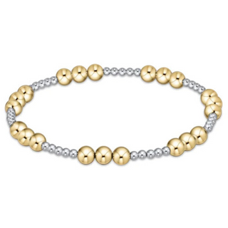 Bracelet with gold and silver beads on a white background by enewton