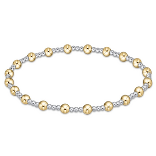 Two-tone gold and silver beaded bracelet on a white background by enewton