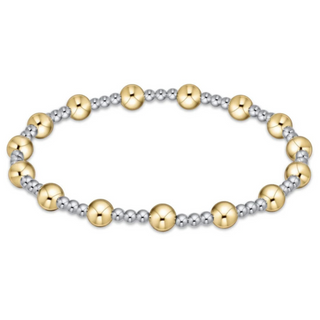 Bracelet with alternating gold and silver beads on a white background by enewton