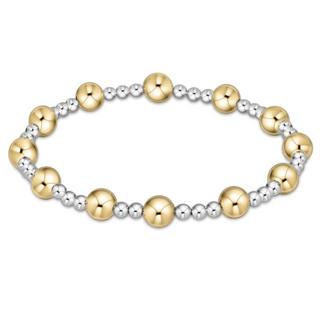Bracelet with gold and silver beads on a white background by enewton
