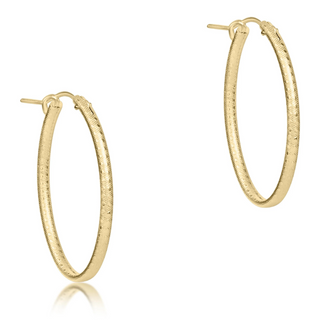 Gold textured hoop earrings on a white background by enewton