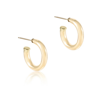 Gold hoop earrings on a white background by enewton