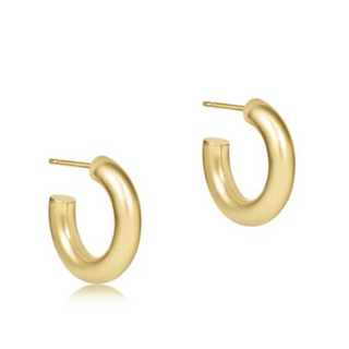 Gold hoop earrings on a white background by e newton